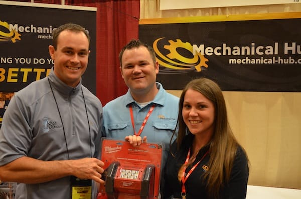 Brian O'Connor (l), wins the Milwaukee Tool LED Flood Light. The Hub's Eric Aune and wife Heather give away the prize.